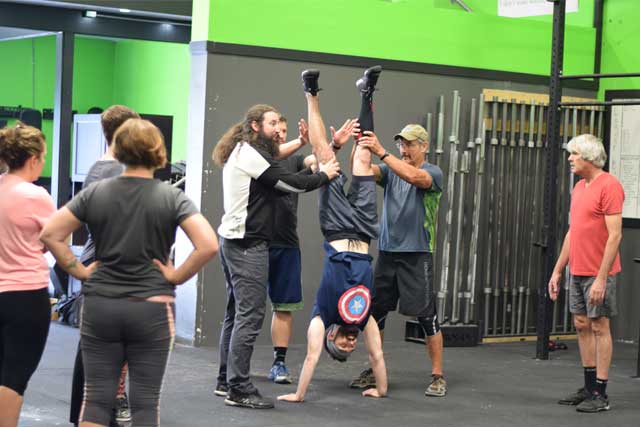 Jesse teaching a group about handstands